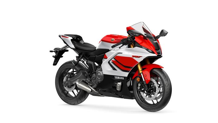 Yamaha 2026 R7 Anniversary Edition A sleek red, white, and black Yamaha YZF motorcycle is displayed, featuring a sporty design, aerodynamic fairings, and prominent branding on the side.