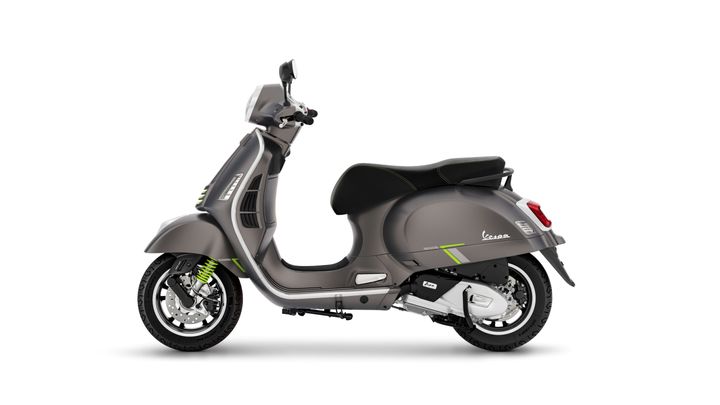 A sleek gray Vespa scooter with green accents, displayed in profile against a white background.