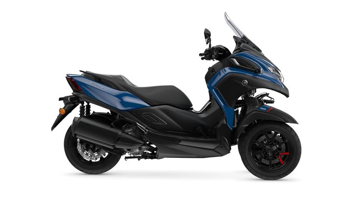 A side view of a blue Yamaha scooter with a sleek design, featuring a dual front wheel and a comfortable seat.