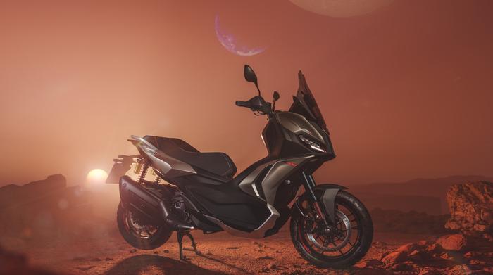 A sleek motorcycle stands on a reddish, rocky terrain under a dramatic sky with large moons and a distant sun setting.