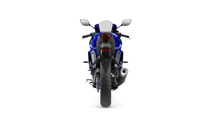 A blue sports motorcycle viewed from the rear, showcasing its sleek design, tail lights, and rear tire.