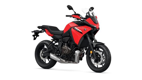 A red Yamaha motorcycle with a sporty design, featuring a sleek body, black accents, and a modern front fairing. The bike is positioned at an angle, showcasing its front wheel and exhaust system.
