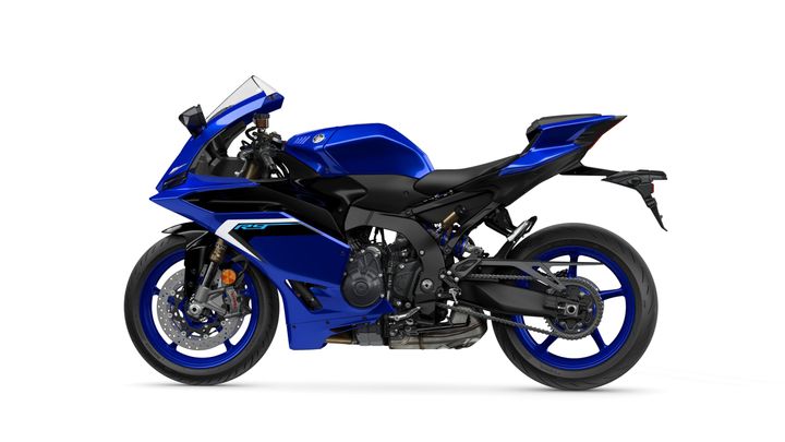 A blue Yamaha sport motorcycle with a sleek design, featuring a black seat and frame, positioned against a white background.