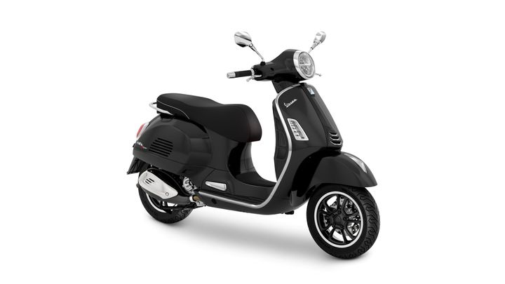 A sleek black Vespa scooter viewed from the side, showcasing its elegant design, glossy finish, and distinctive features such as the round headlight and sporty wheels.