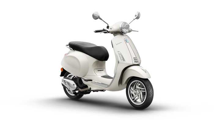 A modern cream-colored scooter with a black seat, featuring chrome accents and a classic design, positioned at an angle to showcase its detailed front and profile.