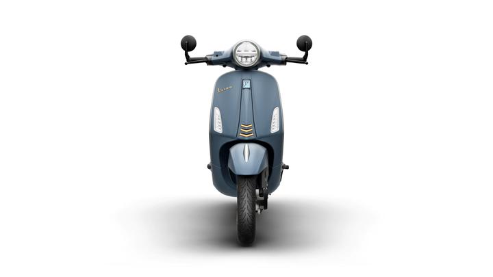 Front view of a blue scooter with a round headlight and rearview mirrors, set against a white background.