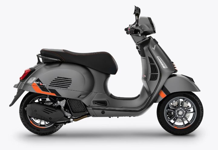 A modern gray scooter with orange accents on a white background.