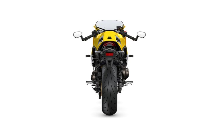 A rear view of a yellow motorcycle with a sleek design, showcasing the tail light, handlebars, and large rear tire against a white background.