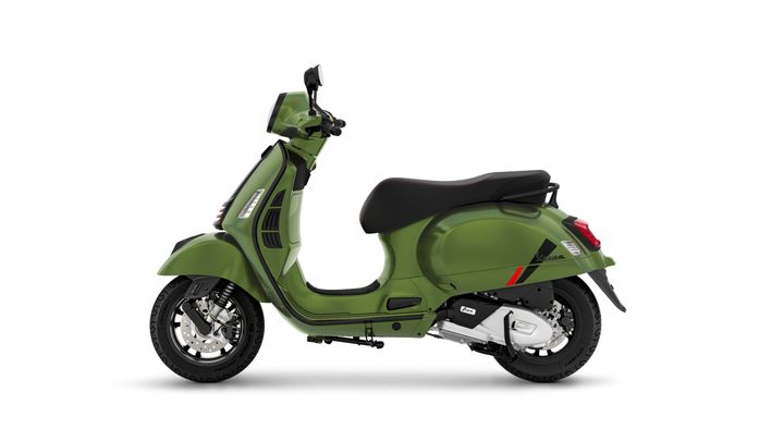 A green vintage scooter with a black seat, viewed from the side, showcasing its sleek design and modern features.