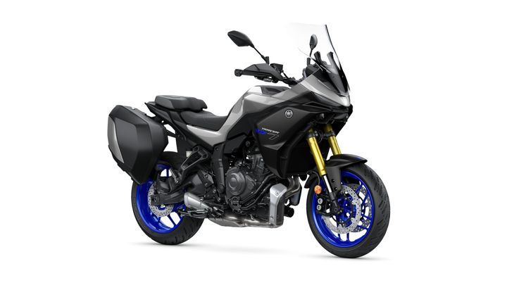 A sleek black and gray sport touring motorcycle with blue wheels and saddlebags, featuring a tall windscreen and a powerful build, positioned on a white background.
