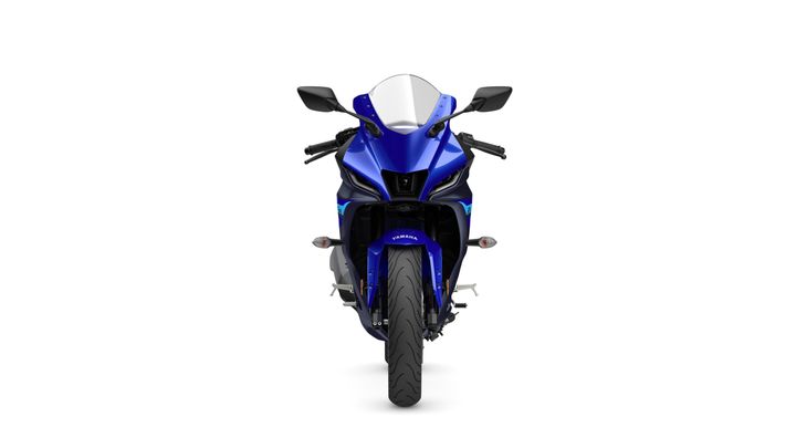 A front view of a blue and black sport motorcycle with sharp lines, a prominent windshield, and dual headlights.