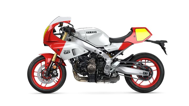 A side view of a Yamaha XSR 900 GP motorcycle featuring a modern design with a white and red color scheme, sport fairing, and distinctive red wheels.