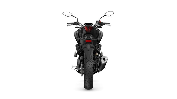 A rear view of a black motorcycle with a prominent tire, dual mirrors, and a sleek design, showcasing the tail light and exhaust.