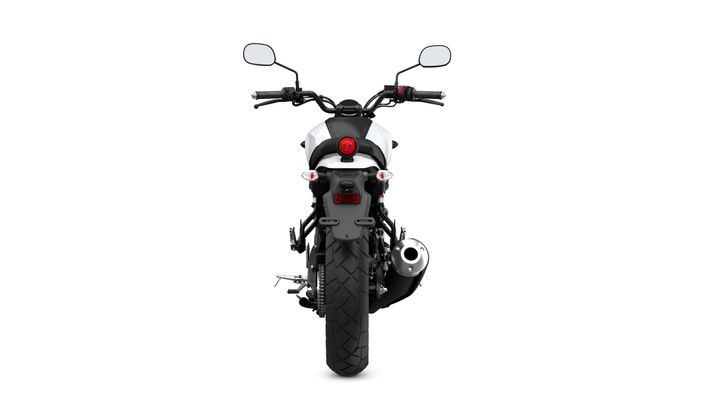A rear view of a motorcycle with a black and white design, featuring handlebars, mirrors, a round red taillight, and a large rear tire with a shiny exhaust pipe.