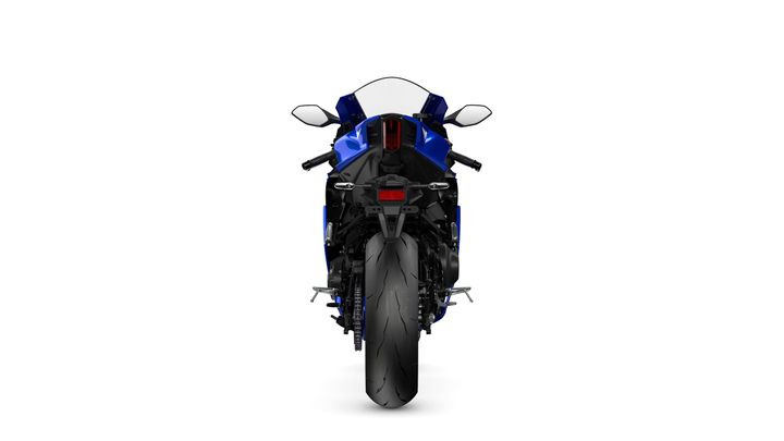 A rear view of a sleek blue sports motorcycle with a large rear tire and dual exhausts, set against a white background.