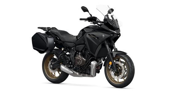 A black Yamaha motorcycle with a sleek design, equipped with a transparent windscreen, side panniers, and golden alloy wheels, positioned on a white background.