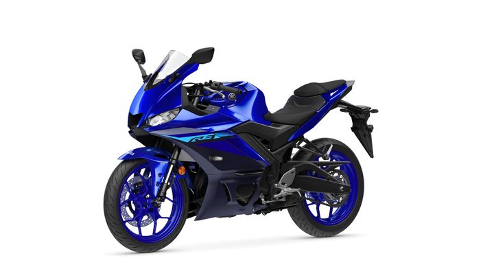 A blue Yamaha motorcycle, model R3, displayed at an angle showing its sleek design, front wheel, and seating area.