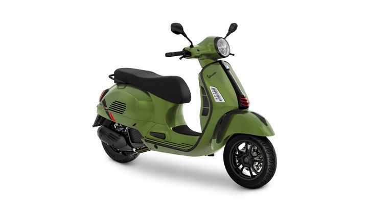 A green vintage-style scooter featuring a sleek design, black accents, and a comfortable seat.