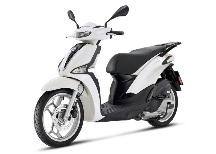 A sleek white scooter with a black seat and modern design, positioned at an angle to showcase its front and side.