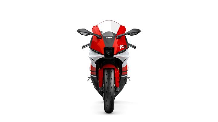 Front view of a Yamaha R9 motorcycle in red and white, showcasing its sleek design and prominent headlights against a plain white background.