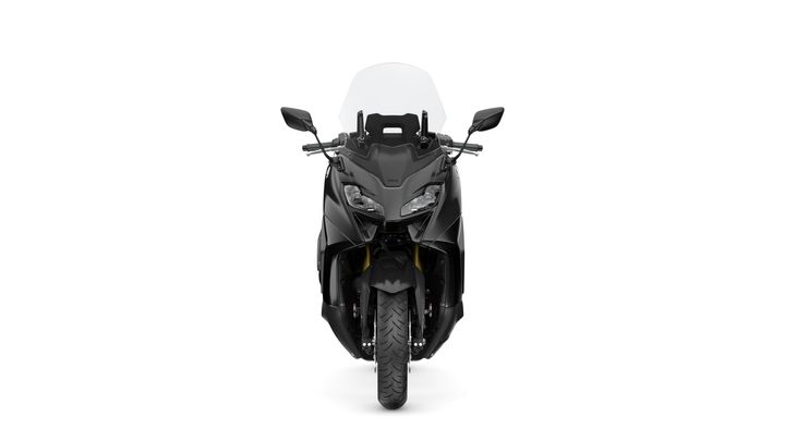 Front view of a sleek black motorcycle with a large windshield and dual headlights, set against a white background.