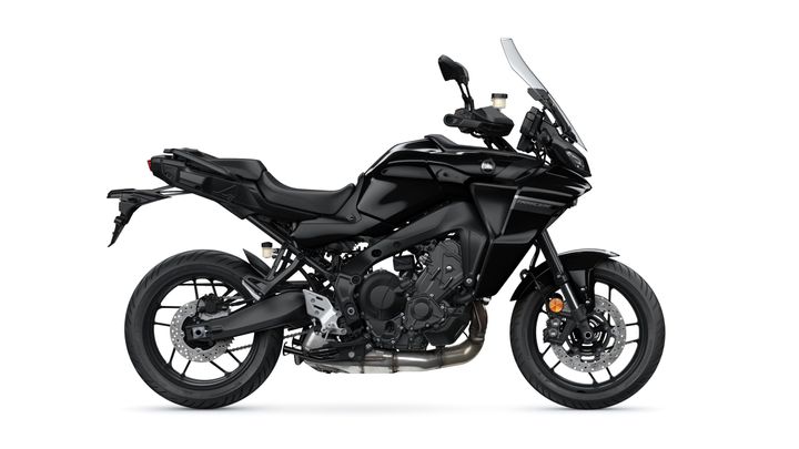 A sleek, black motorcycle with a sporty design, featuring a tall windscreen, low seat, and modern styling, positioned on a white background.