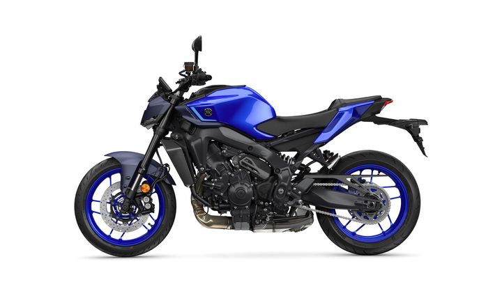 A side view of a blue and black motorcycle showcasing its sleek design, alloy wheels with blue accents, and a modern, sporty frame.