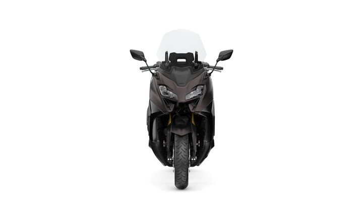 A front view of a sleek, dark-colored motorcycle with a transparent windscreen, showcasing its streamlined design and robust tire.