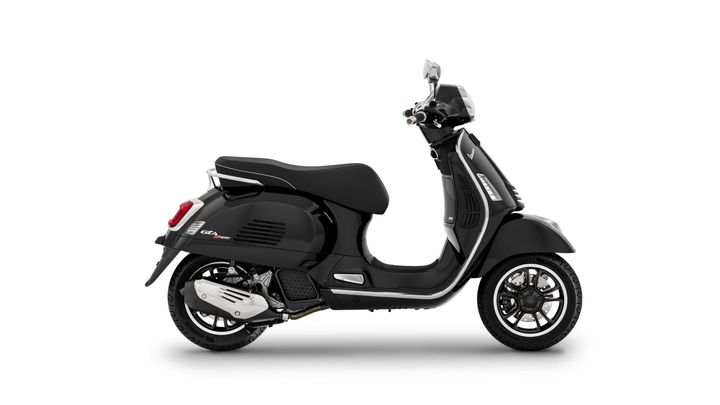 A sleek black scooter positioned sideways, showcasing its modern design, chrome accents, and detailed wheel features against a white background.