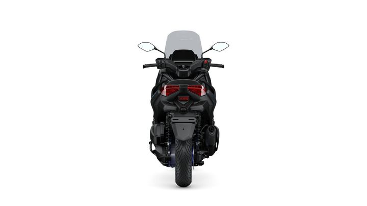 A black motorcycle viewed from the rear, showcasing its sleek design, dual taillights, and a large windshield.